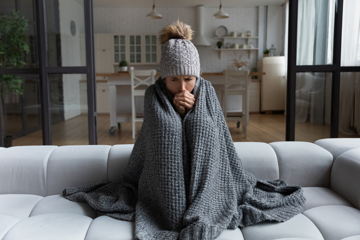 latina-female-shiver-at-freezing-flat-in-warm-cap-blanket