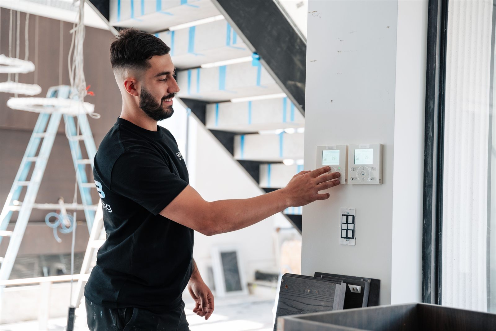 Gemin3 technician setting a Daikin wall controller on a Sydney installation
